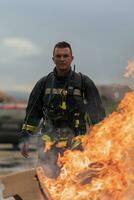 Close-up portrait of a heroic fireman in a protective suit. Firefighter in fire fighting operation. photo