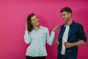 A happy young couple sitting on the floor in the house and making selfie photo