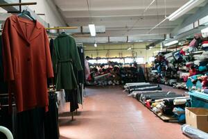 Interior of an industrial warehouse with fabric rolls samples. Small business textile colorful warehouse. photo