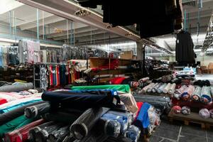 Interior of an industrial warehouse with fabric rolls samples. Small business textile colorful warehouse. photo