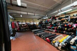 Interior of an industrial warehouse with fabric rolls samples. Small business textile colorful warehouse. photo