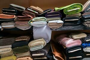 Interior of an industrial warehouse with fabric rolls samples. Small business textile colorful warehouse. photo