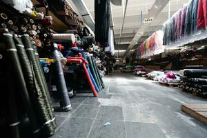 Interior of an industrial warehouse with fabric rolls samples. Small business textile colorful warehouse. photo