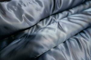 Collection of fashionable fabrics. Samples of different natural fabrics for sewing a fashion collection of clothes. Large selection of fabrics in the store or tailor warehouse. photo