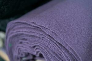 Collection of fashionable fabrics. Samples of different natural fabrics for sewing a fashion collection of clothes. Large selection of fabrics in the store or tailor warehouse. photo