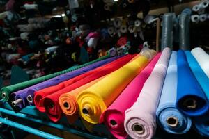 Interior of an industrial warehouse with fabric rolls samples. Small business textile colorful warehouse. photo