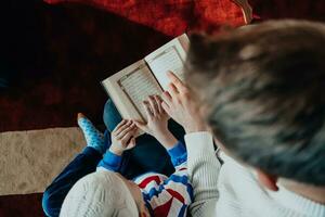 Muslim prayer father and son in mosque praying and reading holly book Quran together islamic education concept photo