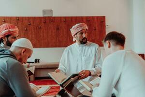 A group of Muslims reading the holy book of the Quran in a modern mosque during the Muslim holiday of Ramadan photo