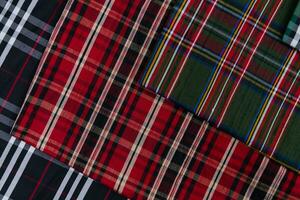 Collection of Scottish fashionable fabrics . Samples of different natural fabrics for sewing a fashion collection of clothes. Large selection of fabrics in the store or tailor warehouse. photo