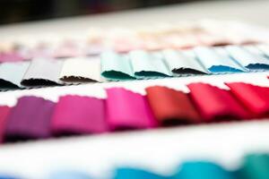 Tailor's workplace, thread spools and fabric samples in the atelier. Small business owners concept photo