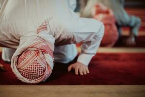 un grupo de musulmanes en un moderno mezquita Orando el musulmán oración namaz, durante el santo mes de Ramadán foto