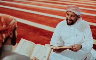 A group of Muslims reading the holy book of the Quran in a modern mosque during the Muslim holiday of Ramadan photo