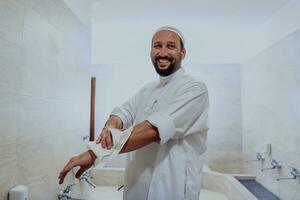 A portrait of a man in abdesthana using a towel photo