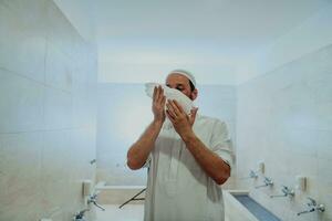 A portrait of a man in abdesthana using a towel photo