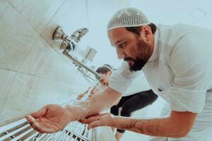 A Muslim performing ablution. Ritual religious cleansing of Muslims before performing prayer. The process of cleansing the body before prayer photo