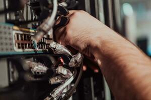 Close up of technician setting up network in server room photo