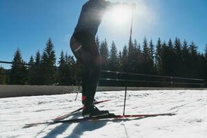 Nordic skiing or Cross-country skiing classic technique practiced by man in a beautiful panoramic trail at morning. photo