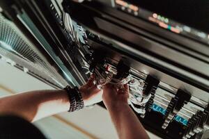 Close up of technician setting up network in server room photo