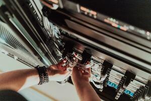 Close up of technician setting up network in server room photo