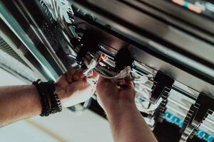 Close up of technician setting up network in server room photo