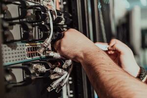 Close up of technician setting up network in server room photo