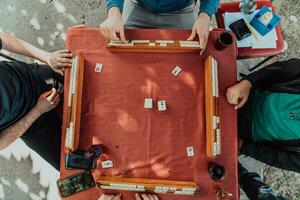 A group of men drink traditional Turkish tea and play a Turkish game called Okey photo