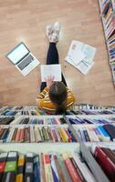 the student uses a notebook and a school library photo