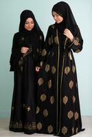 Two beautiful muslim woman in fashinable dress with hijab isolated on modern cyan background representing concept of modern islam and ramadan kareem photo
