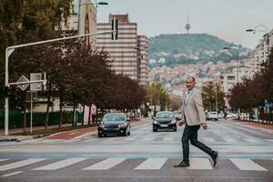 focused businessman in suit walking in urban environment. photo