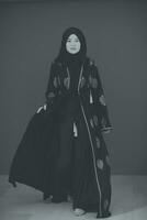 Black white photo of beautiful muslim woman in fashinable dress with hijab
