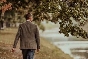 Focused businessman in a suit walking in the park photo