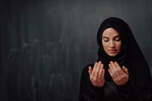 Portrait of young Muslim woman making dua photo