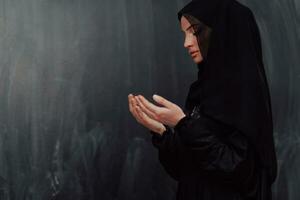 Portrait of young Muslim woman making dua photo