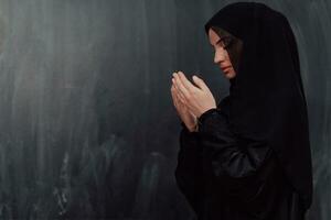 Portrait of young Muslim woman making dua photo