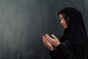 Portrait of young Muslim woman making dua photo