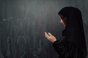 Portrait of young Muslim woman making dua photo