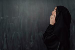 Portrait of young Muslim woman making dua photo