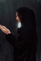 Portrait of young Muslim woman making dua photo