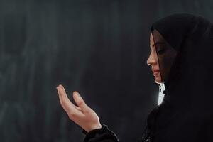 Portrait of young Muslim woman making dua photo