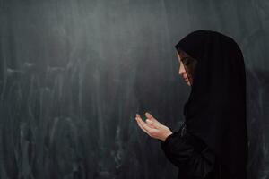 Portrait of young Muslim woman making dua photo