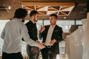 A group of young entrepreneurs on a coffee break discuss the project while using modern editing tablets, a smartphone and a laptop.Business concept photo