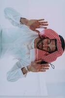 Muslim man doing sujud or sajdah on the glass floor photo