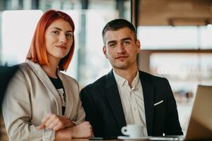 Businessman and businesswoman use modern devices, laptop, tablet and smartphone and arrange new projects for the job. photo