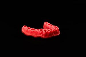 human gums without teeth model medical implant isolated on black background. Healthy teeth, dental care and orthodontic concept. photo