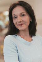 Portrait of a teacher in a preschool institution, in the background of the classrooms photo