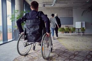 A diverse group of business professionals, including an person with a disability, gathered at a modern office for a productive and inclusive meeting. photo