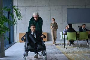 A young entrepreneur and his colleague, who is a person with a disability, fun together through a large, modern office, demonstrating the power of teamwork, inclusivity, and determination as they drive the wheelchair photo