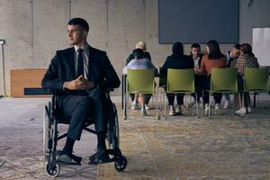 Businessman in a wheelchair commands attention, symbolizing resilience and success amidst a dynamic modern office environment. photo