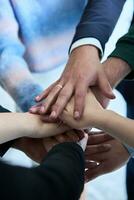 A top view photo of group of businessmen holding hands together to symbolize unity and strength