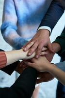 A top view photo of group of businessmen holding hands together to symbolize unity and strength